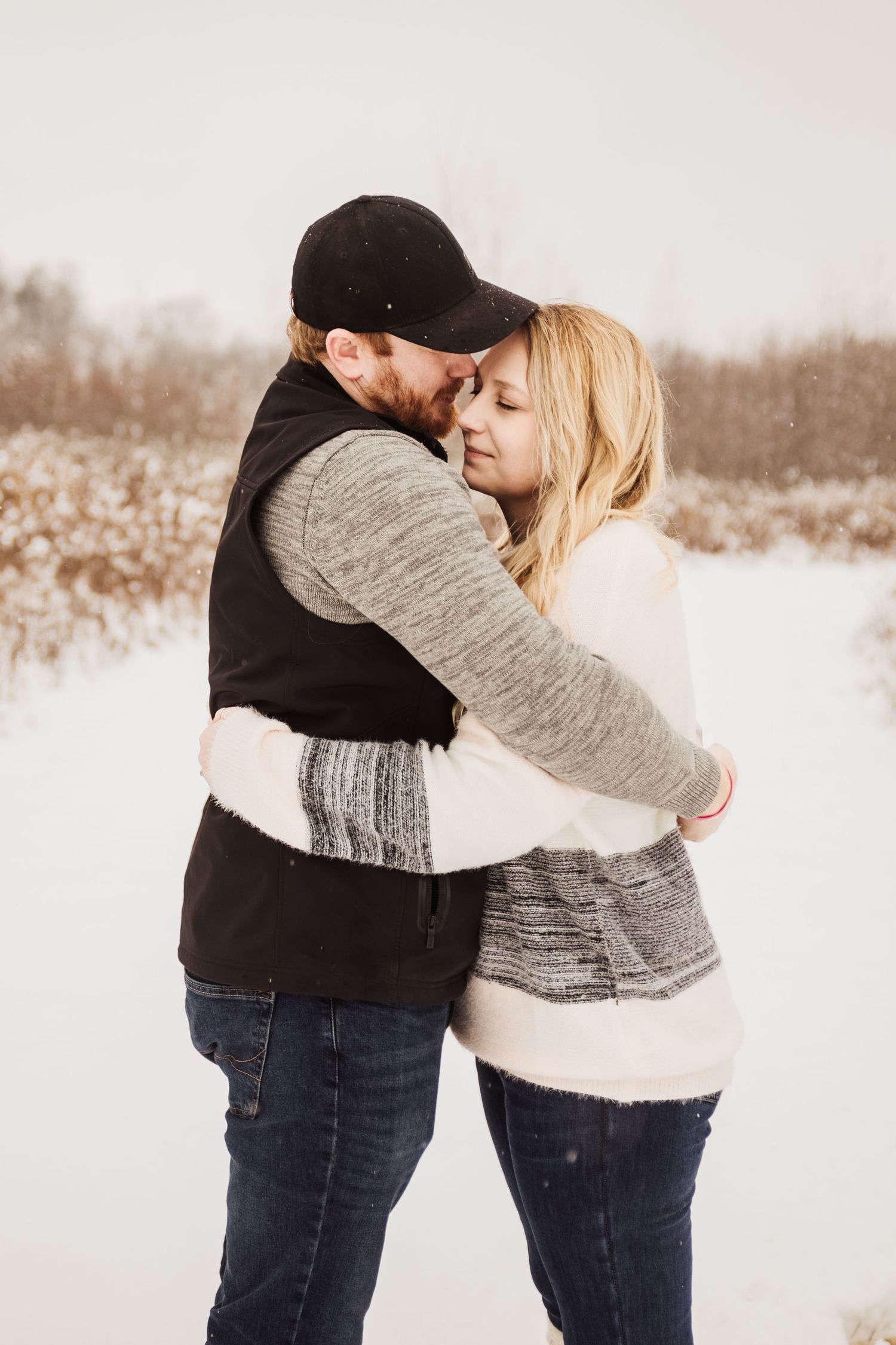An intimate embrace between a couple during their winter engagement photo session.
