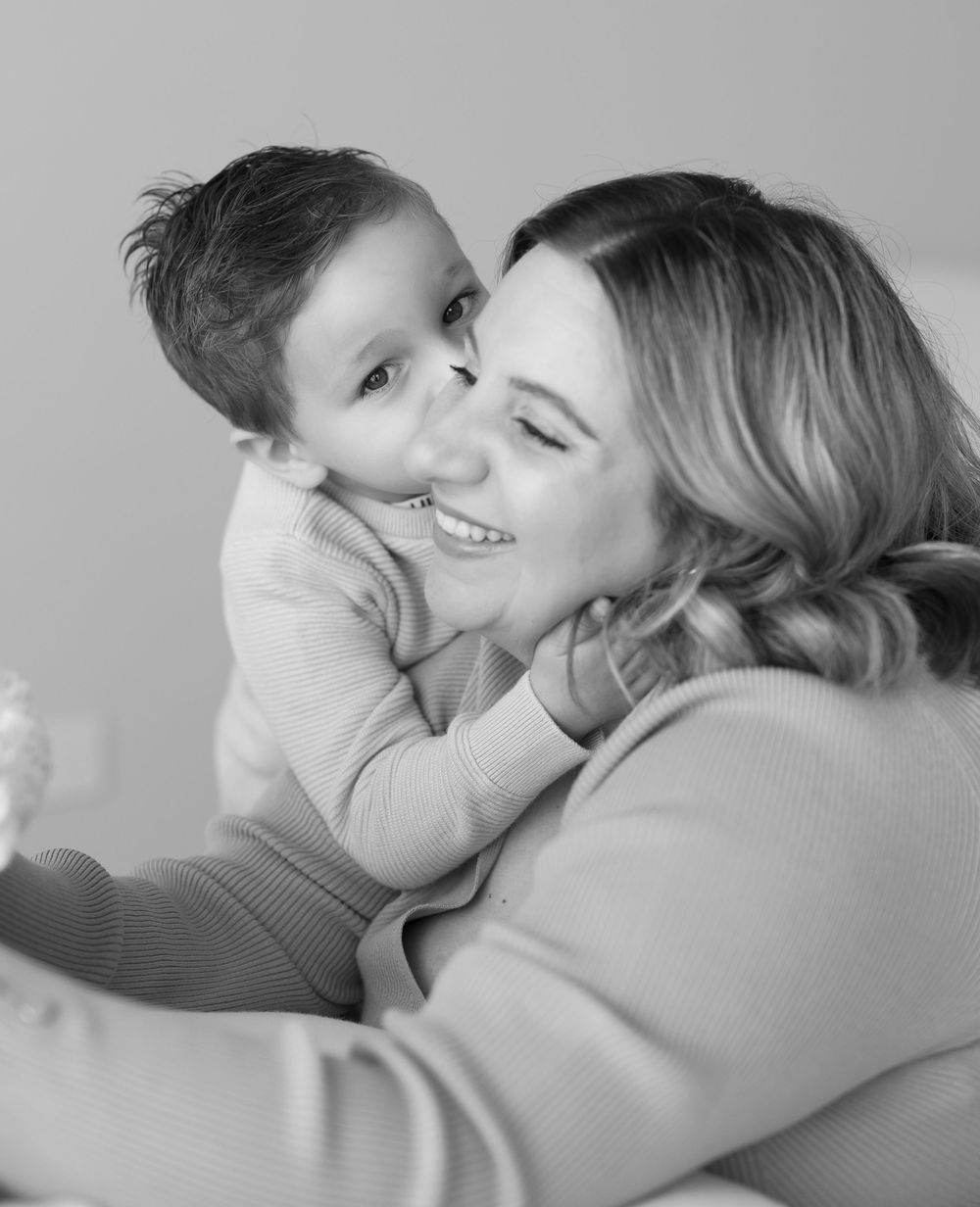 A tender sequence of black and white photographs showing expressions of love and connection between parent and child.