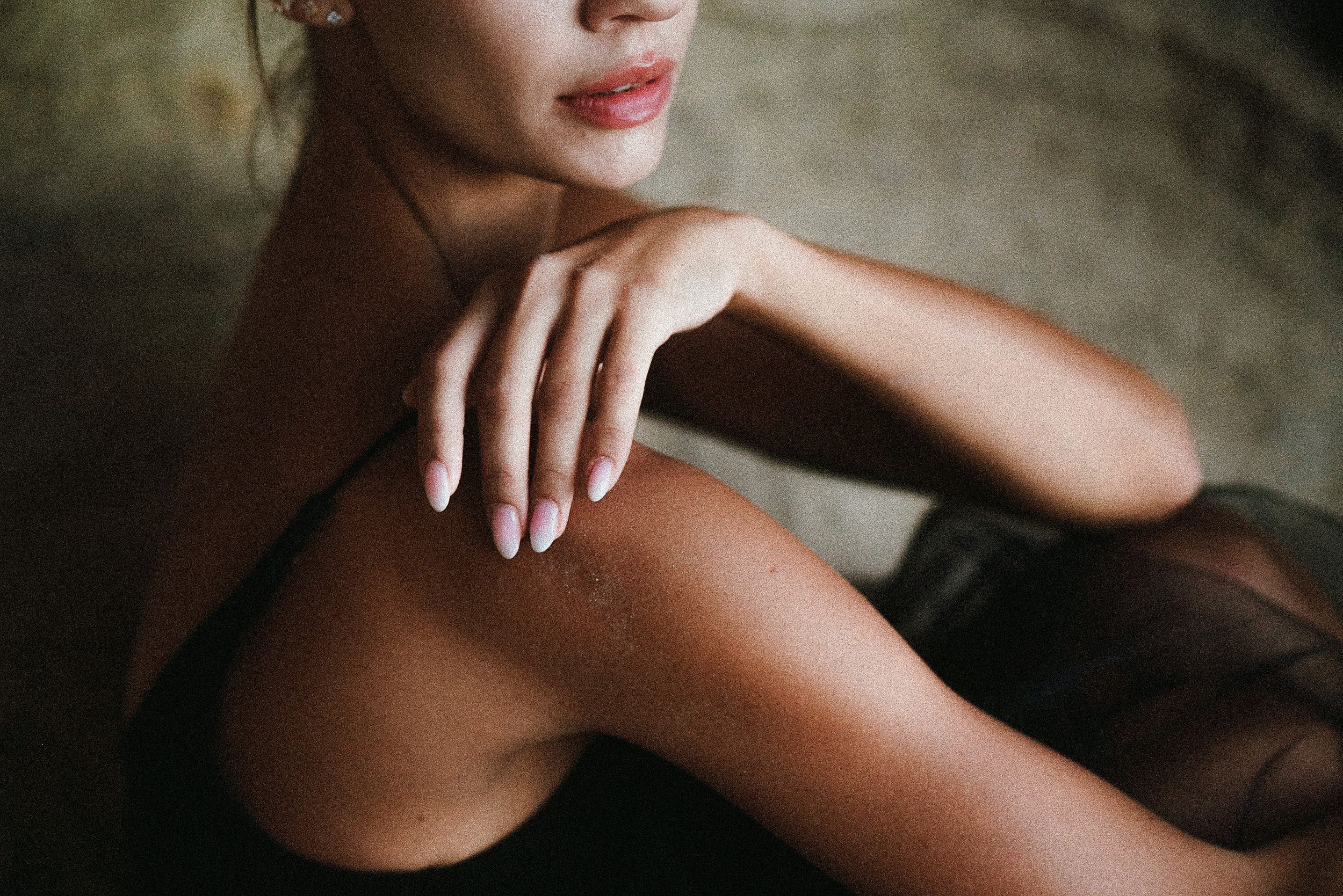 Close-up artistic portrait showing elegant hands, dark fabric, and red lipstick. Tenerife Wedding Photographer in La Caleta de Adeje.