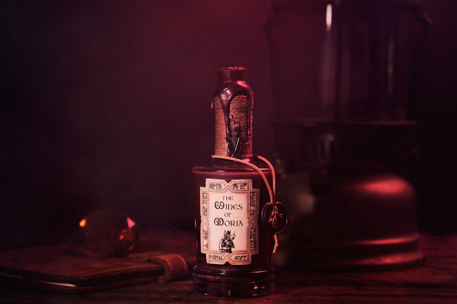 Artistic still life photograph of a bourbon bottle in dark moody lighting with red accents and shadows.