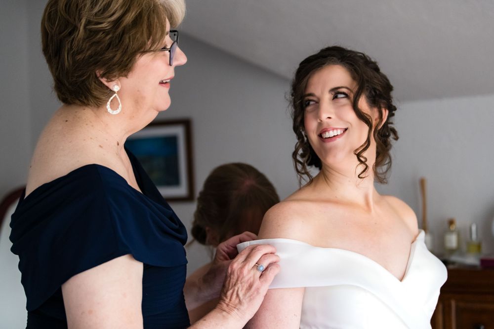 An emotional moment between women during wedding preparations.