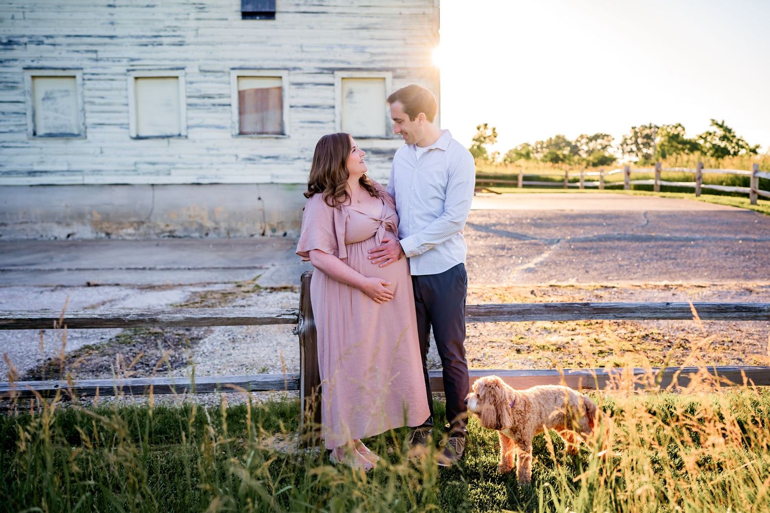 Flowing maternity gown on a pregnant woman, captured during a sunset maternity session.