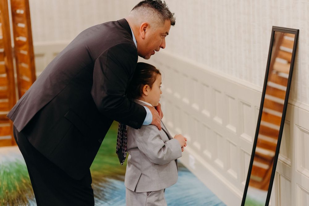 Four sequential photos show a sweet moment between two people embracing on a wooden deck.