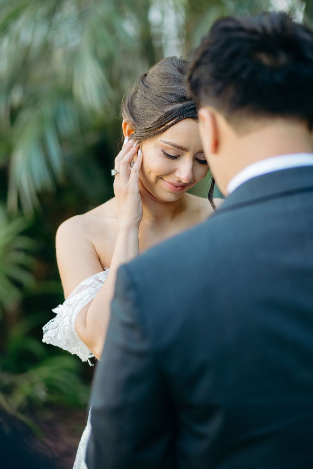 A tender moment between a couple sharing an intimate embrace outdoors.