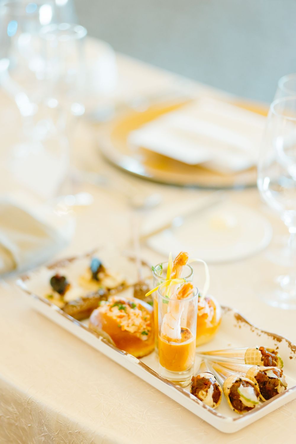 Gourmet wedding appetizers elegantly plated on a long white serving dish.