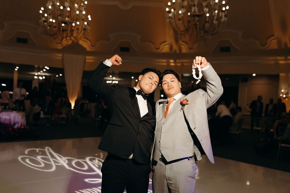 Reception dance floor moment with special lighting effects in an elegant ballroom setting.