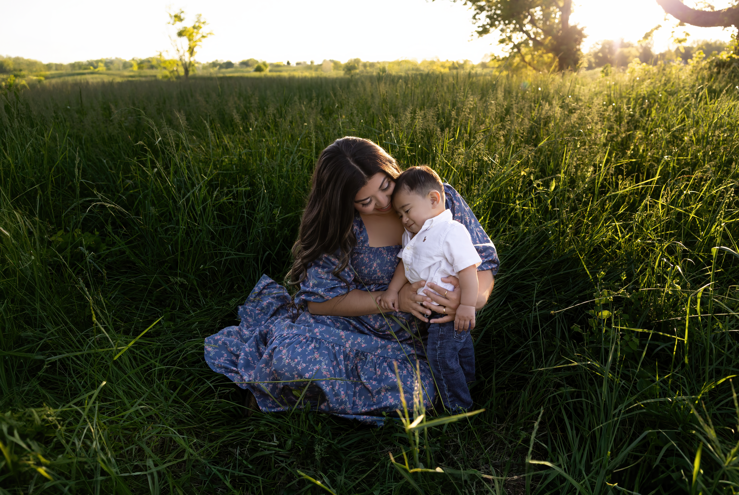 A golden hour maternity session in the Kentucky fields capturing a growing family’s love as they await their second baby boy, photographed b