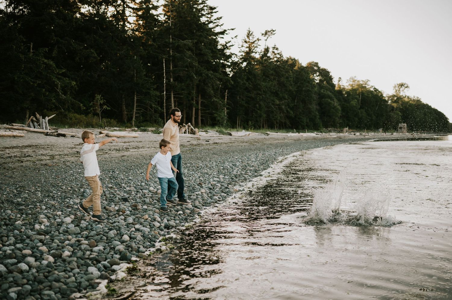 Comox Valley family photoshoot of kids candidly throwing rocks in ocean Kye Bay Beach. Portraits taken by photographer Soulfull Photographs