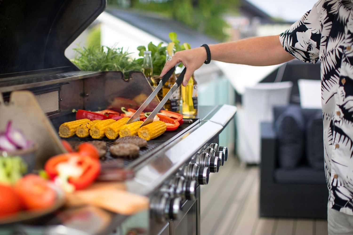 Grilling colorful vegetables and meat on outdoor barbecue grill in summer garden setting.