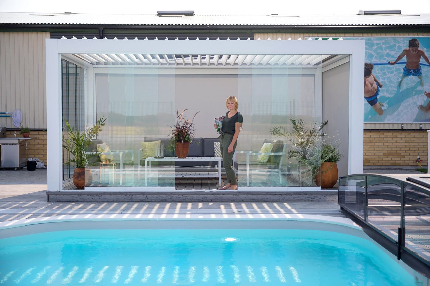 Modern indoor-outdoor space with swimming pool and retractable roof.