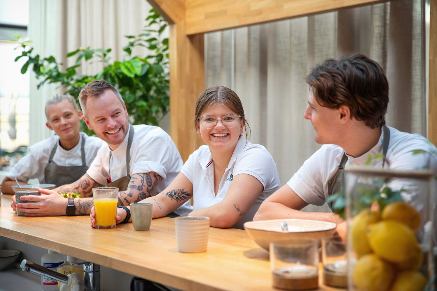 A cheerful group enjoying drinks and conversation at a breakfast bar.
