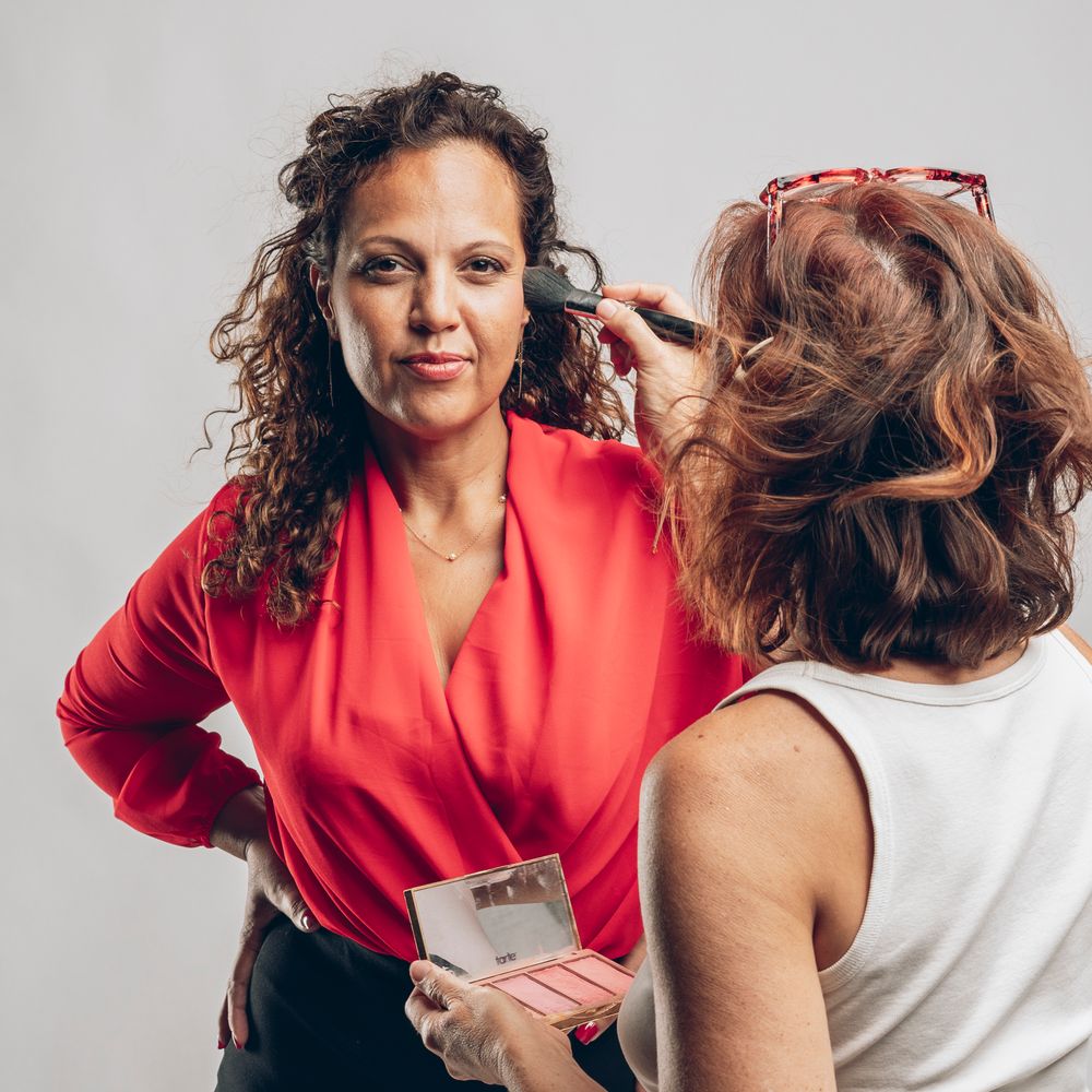 Two women in business attire having a conversation.
