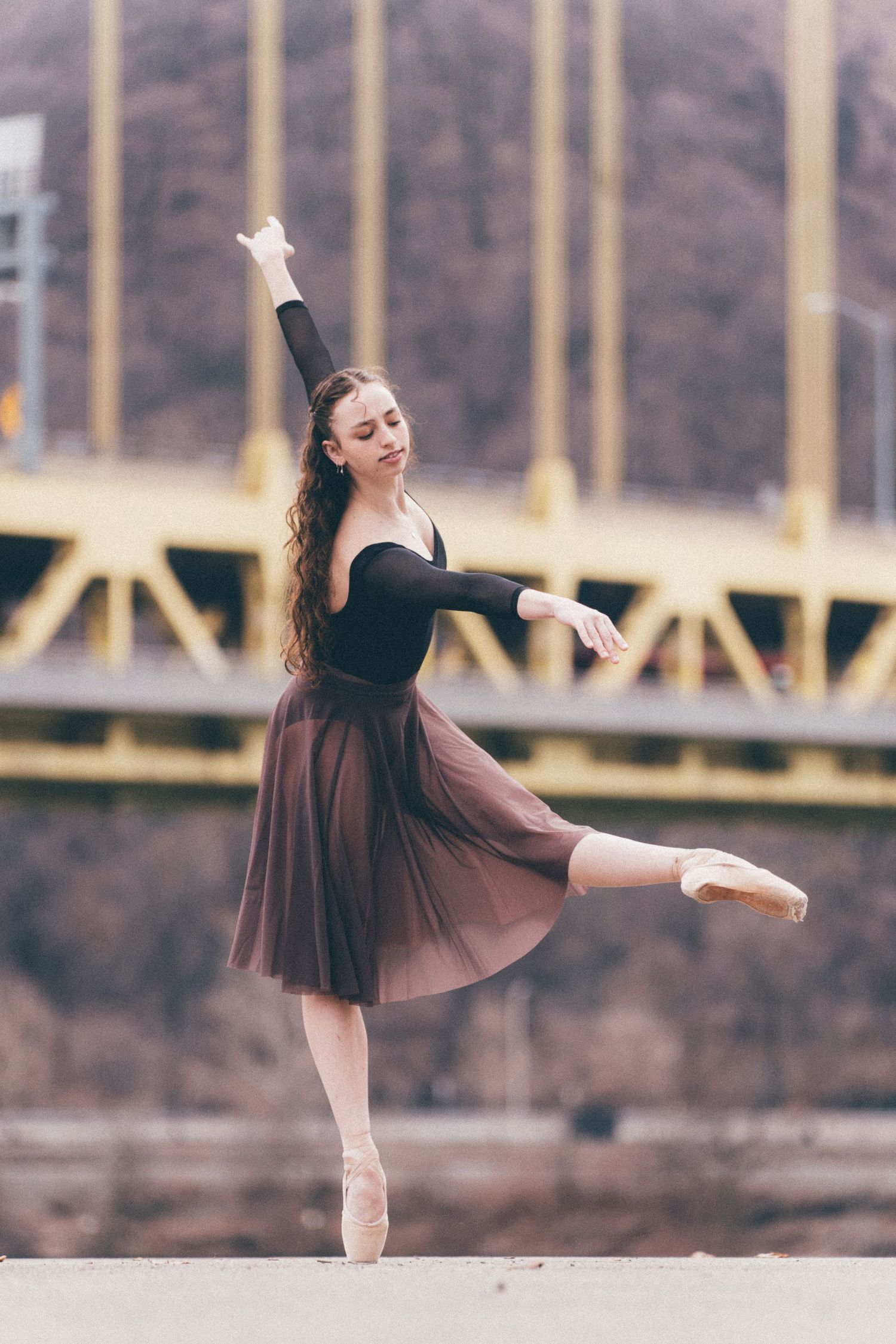 Golden hour ballet photo of a ballerina en pointe on stone pathway at Point State Park, Pittsburgh