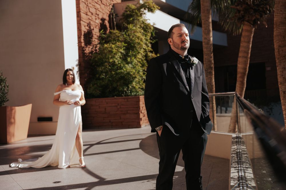 Newlywed couple shares intimate moments during sunset golden hour at a brick building venue.