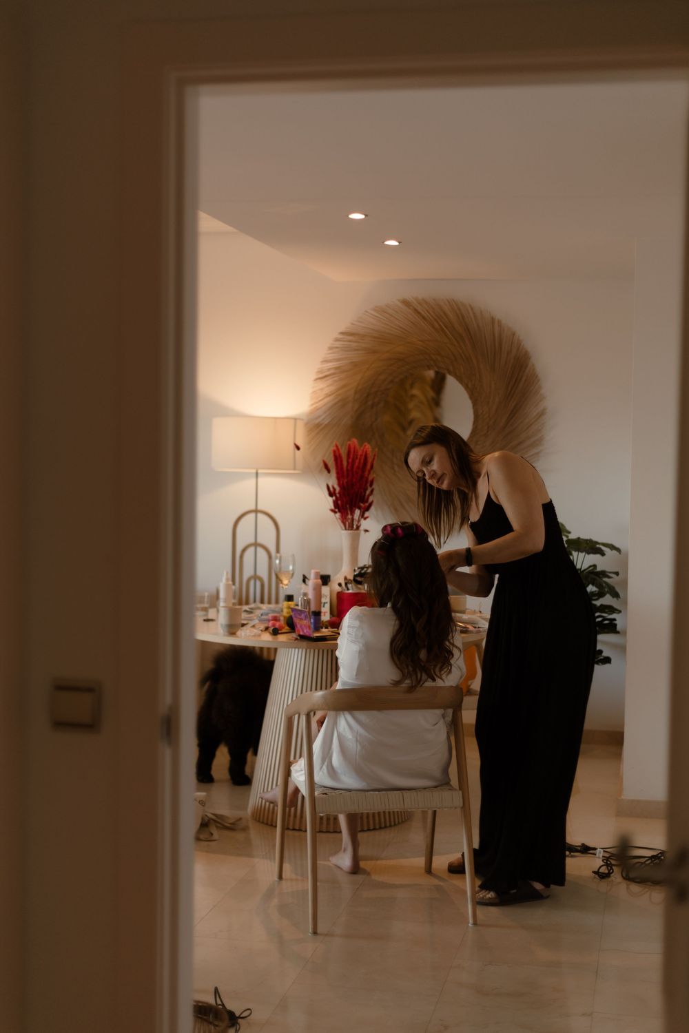 Hairdresser working with a client in an elegant salon setting with soft lighting and modern decor.