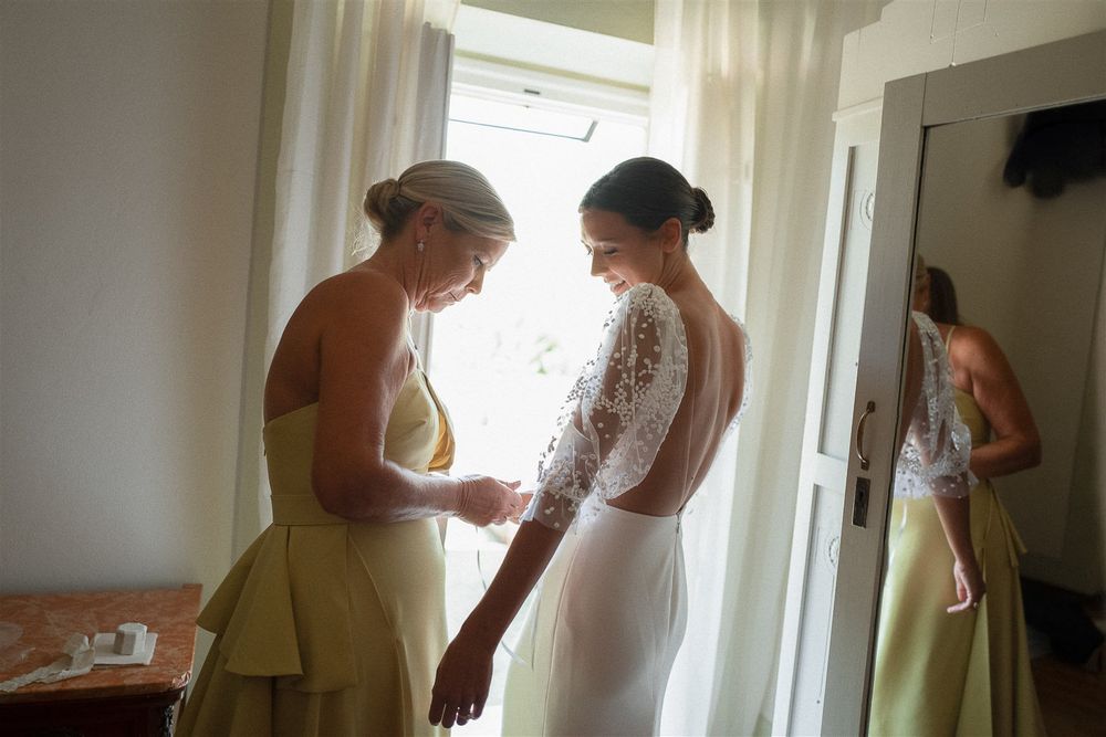 Getting ready scene in a bright room with elegant wedding attire and preparations.