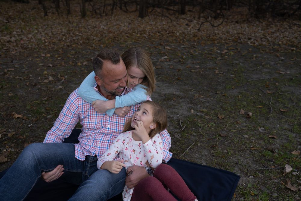 A family shares an intimate moment during their outdoor photo session.