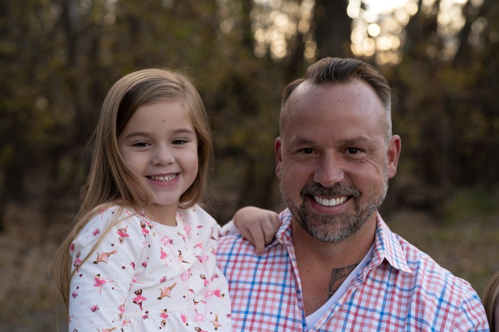 Close-up outdoor portrait showing happy expressions in natural lighting.