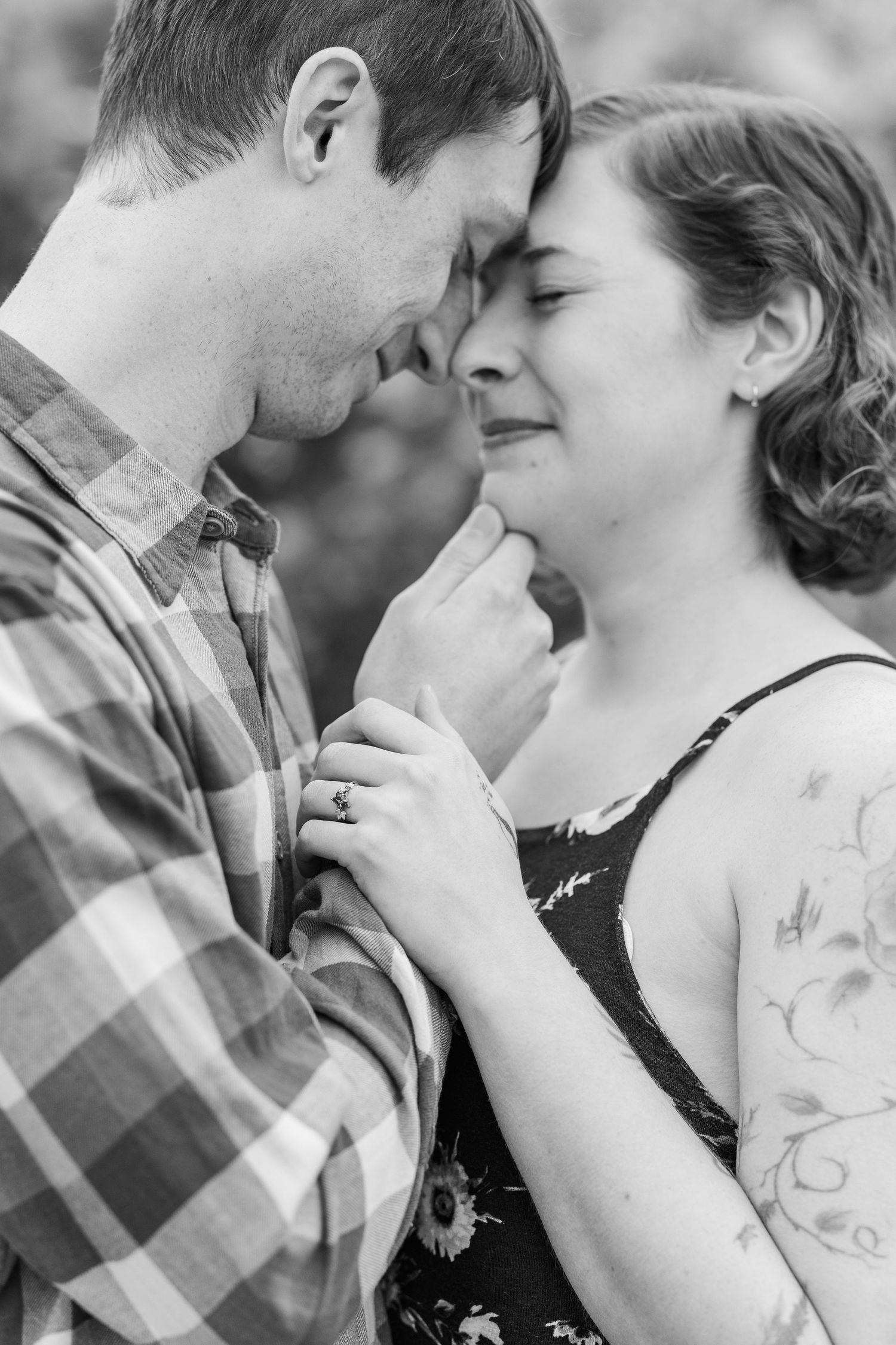 A tender black and white romantic moment between a couple as they share an intimate close embrace outdoors at Cantigny Park