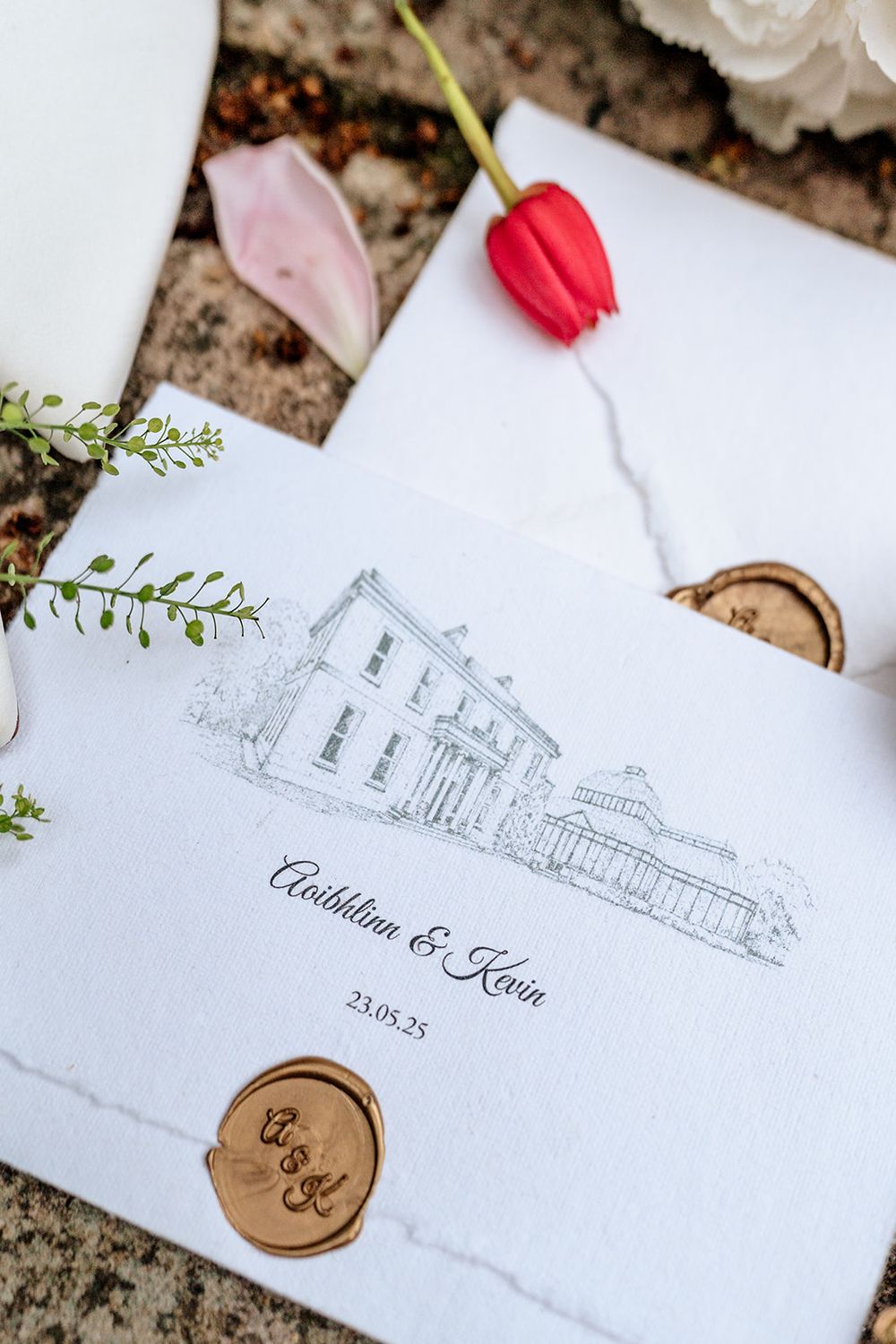 Wedding invitation with architectural sketch and red tulip featuring building illustration and wax seal.