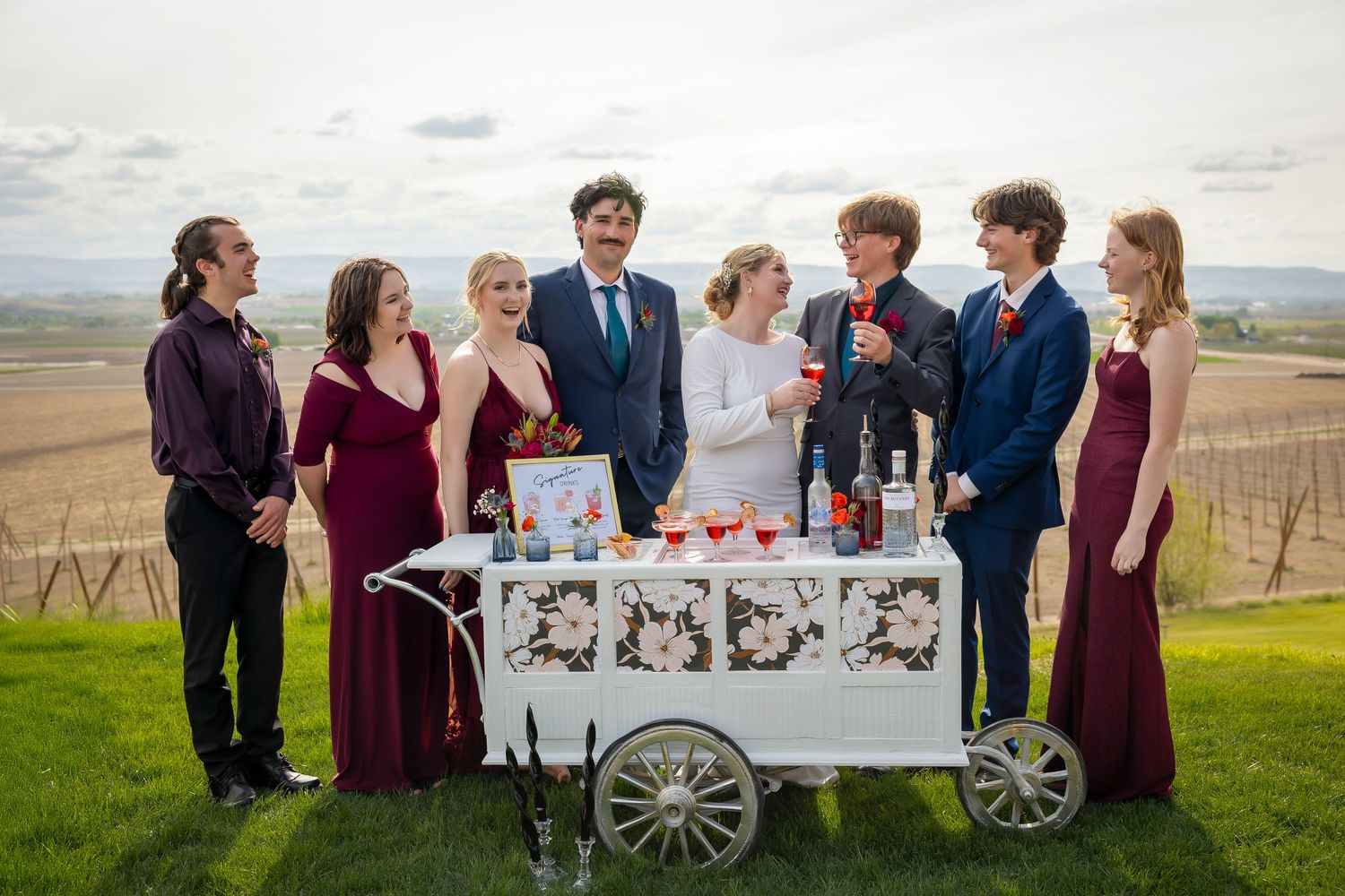 wedding party posing with Tilly the Tipsy Trailer