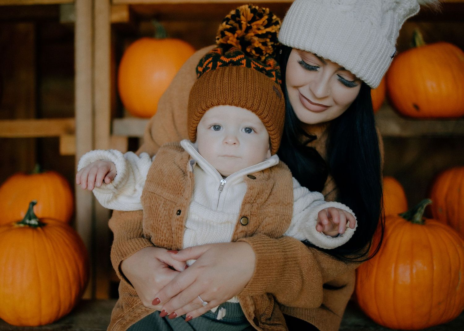 Autumn scene at a pumpkin patch with orange gourds in the background.