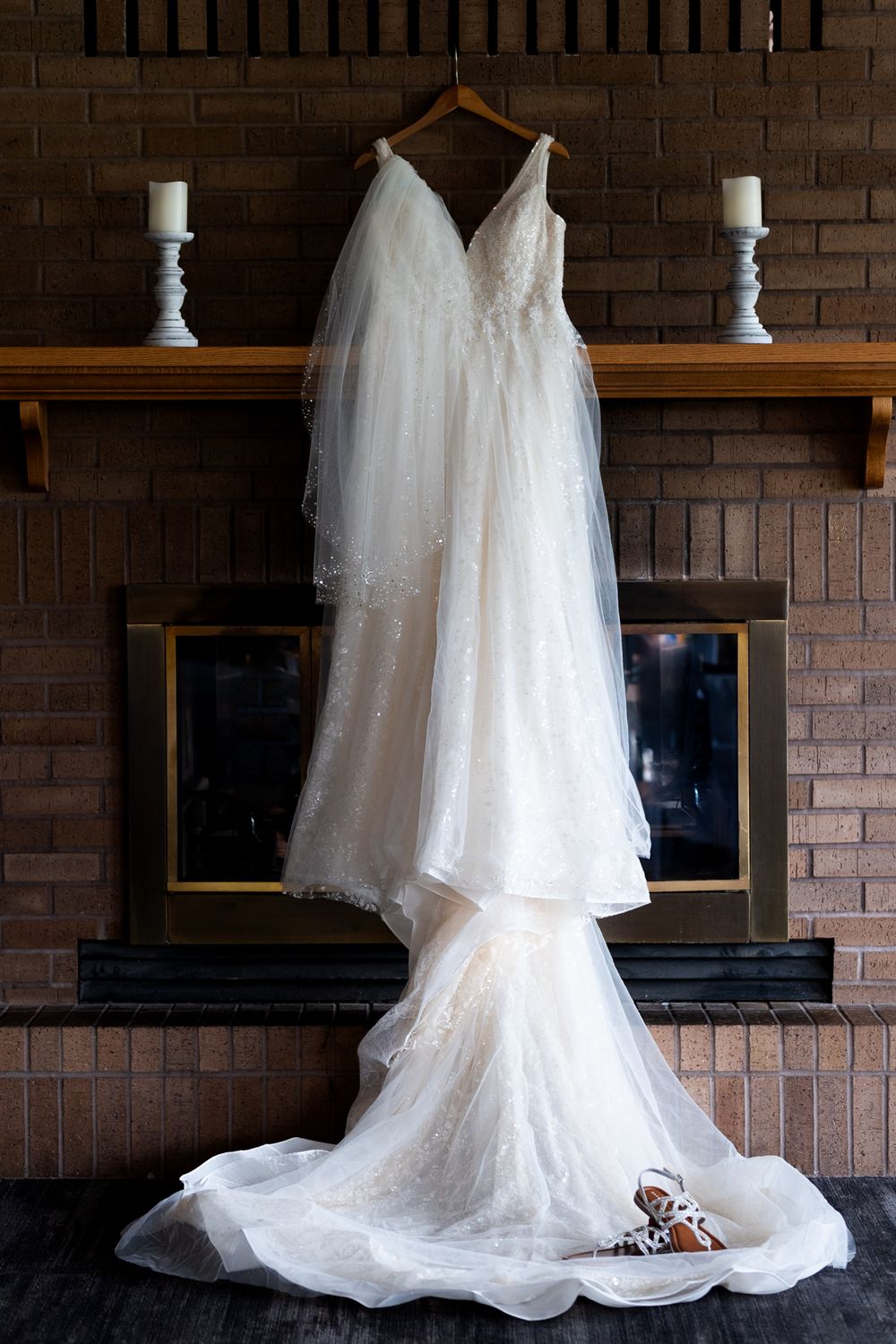 wedding dress and shoes hanging on fire place