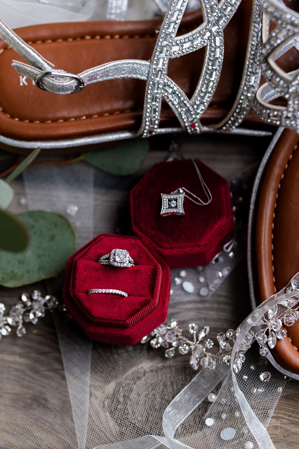 rings in red box with brides shoes and veil