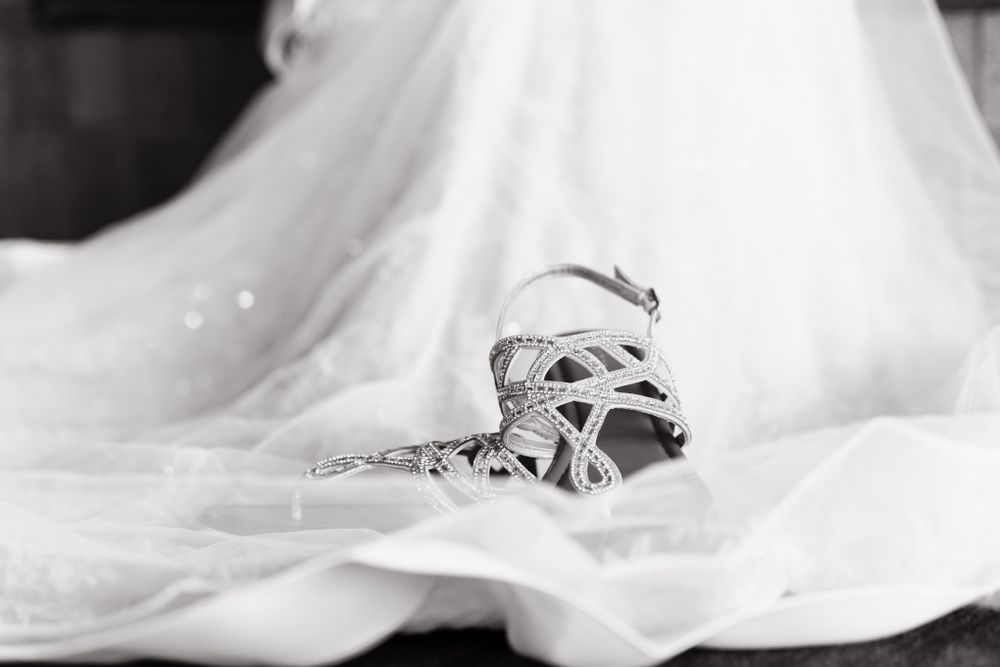 wedding shoes on dress in black and white