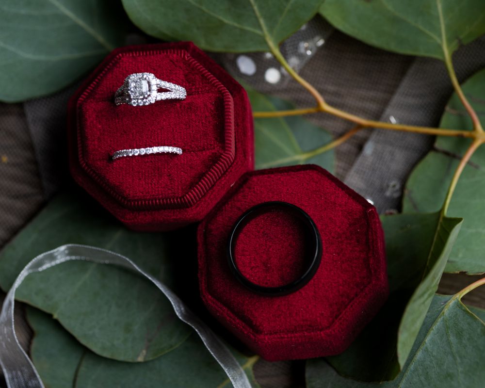 wedding rings resting on red octagon box