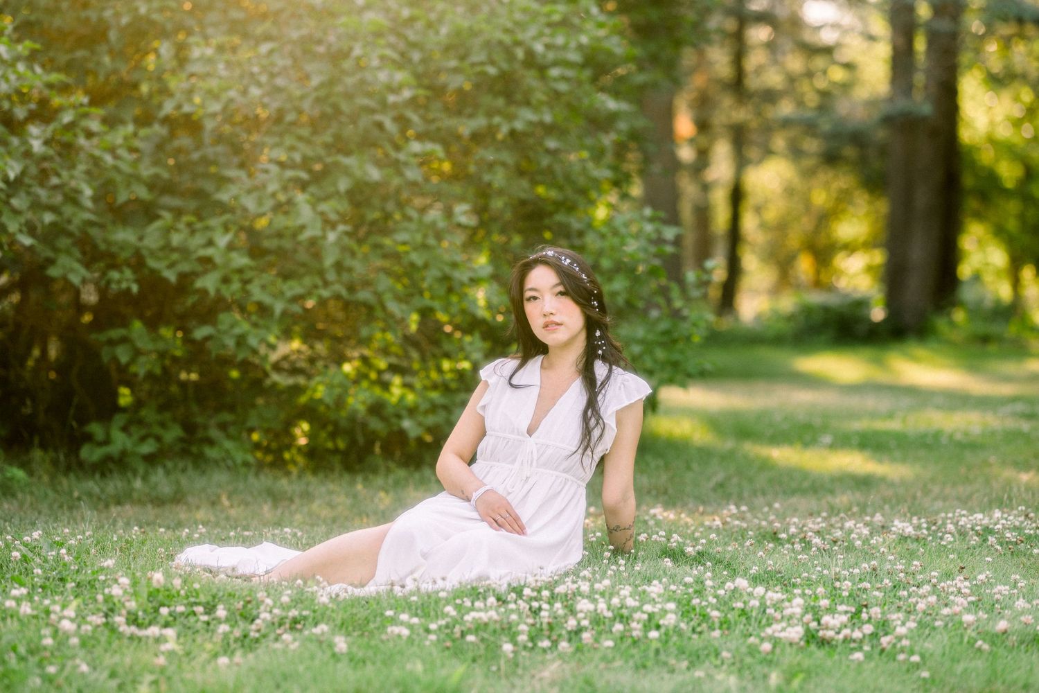 A dreamy summer portrait in a field of wildflowers with soft natural lighting.