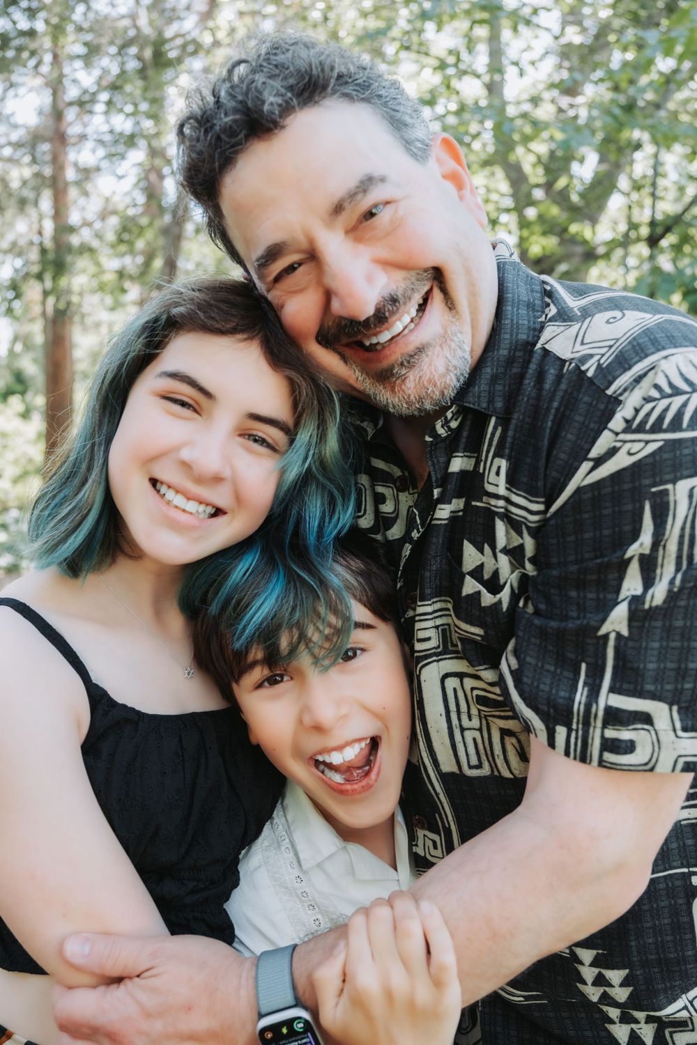 A close-up series of joyful moments with blue-haired young person and adult in a patterned sweater sharing warm embraces.