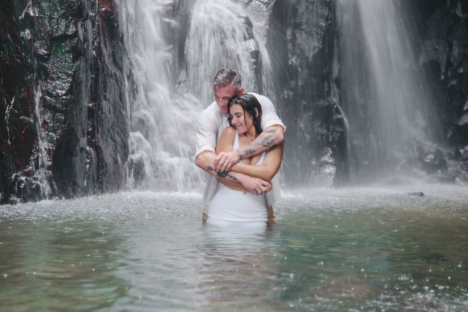 A series of photos showing people enjoying a tropical waterfall lagoon in a lush forest setting.