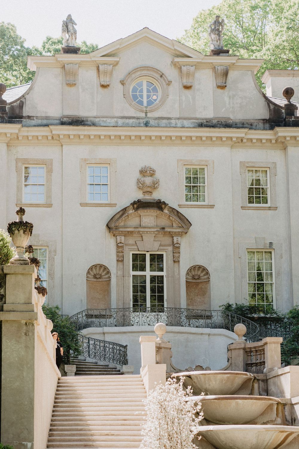 Elegant neoclassical mansion with symmetrical architecture and grand entrance staircase.