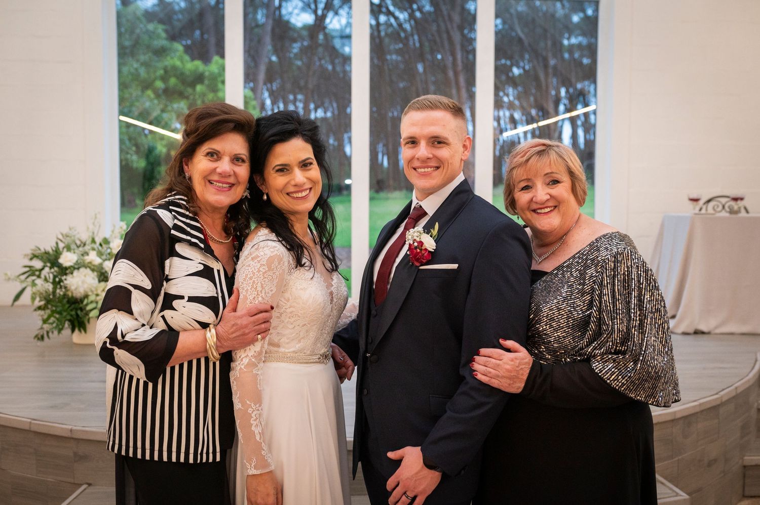 People celebrating and laughing together at a special event in a bright indoor venue.