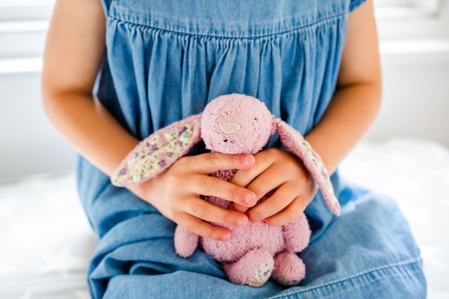 Close up. Child with cuddly toy in hands.