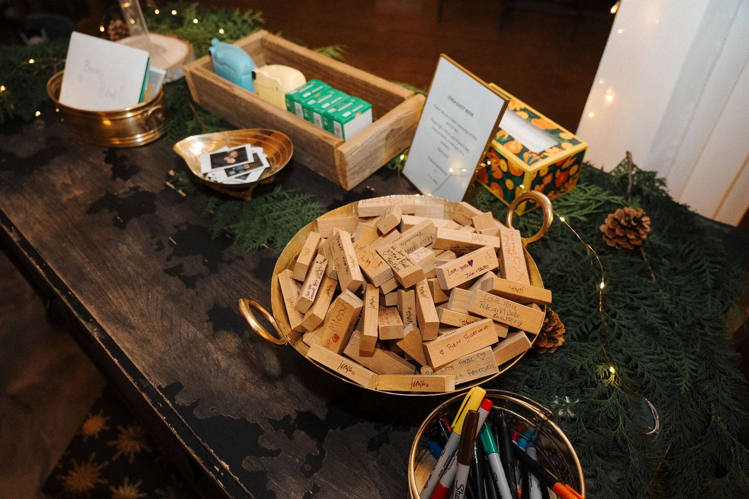 Wooden Palo Santo sticks arranged on a round plate with spiritual ceremony items on a dark wooden table.