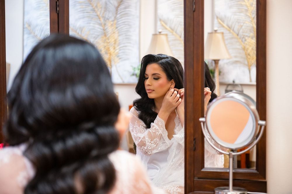 Bride admiring herself in the mirror before the ceremony at Canterbury Hall, captured by Tampa wedding photographer