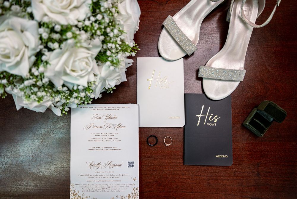 Elegant wedding flat lay with invitation suite, rings, and florals at Canterbury Hall, Tampa Palms