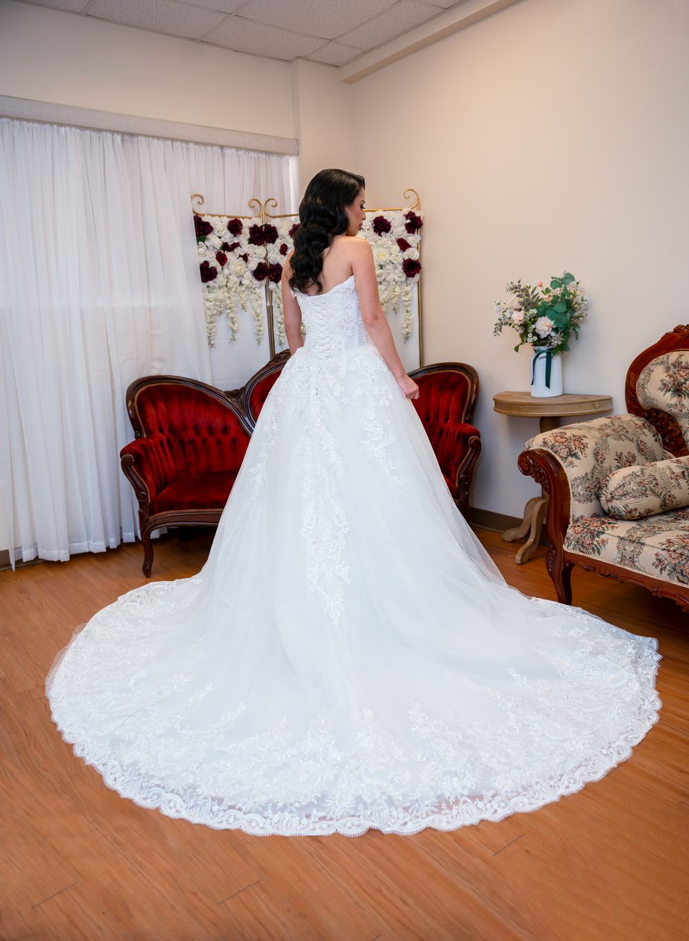 Stunning bride standing in lace wedding gown with natural light pouring in at Canterbury Hall