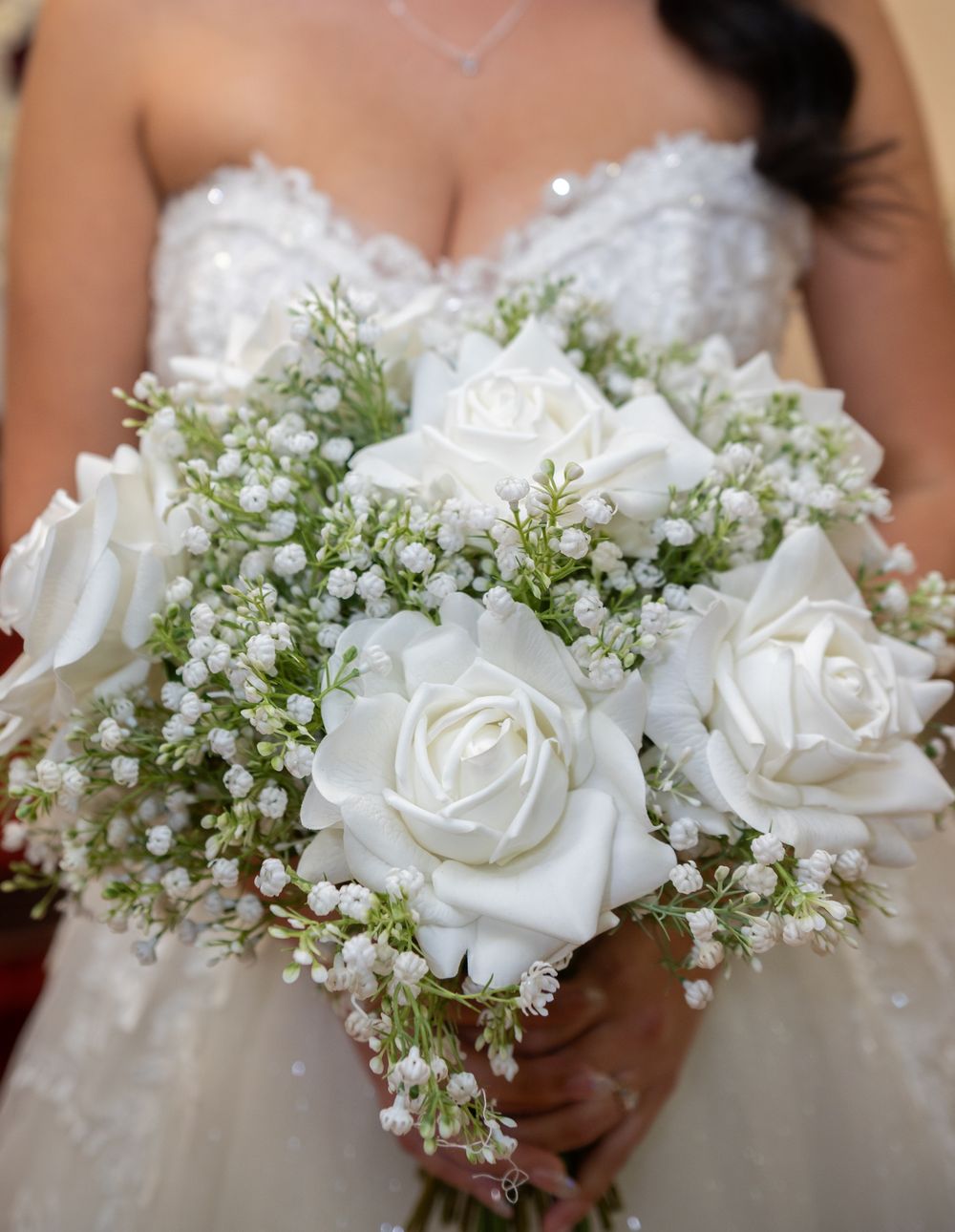 Bride holding spring floral bouquet in front of chapel window at Tampa Palms wedding
