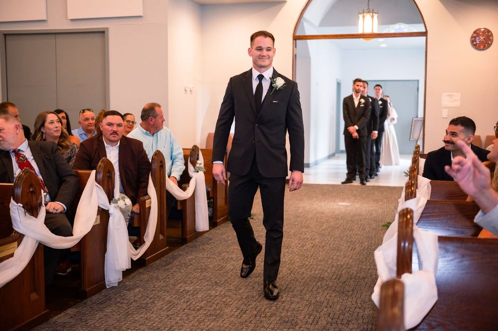 Groom entering Canterbury Hall chapel, ready for wedding ceremony in Tampa