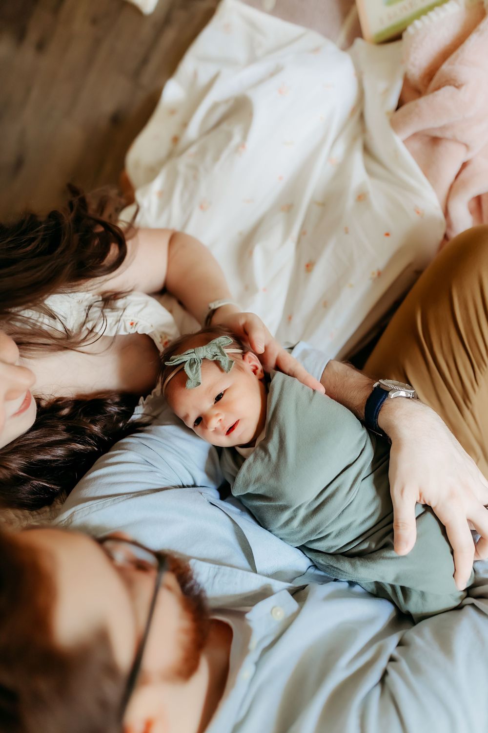 A gentle moment of comfort and relaxation as a family spends time together on soft bedding.