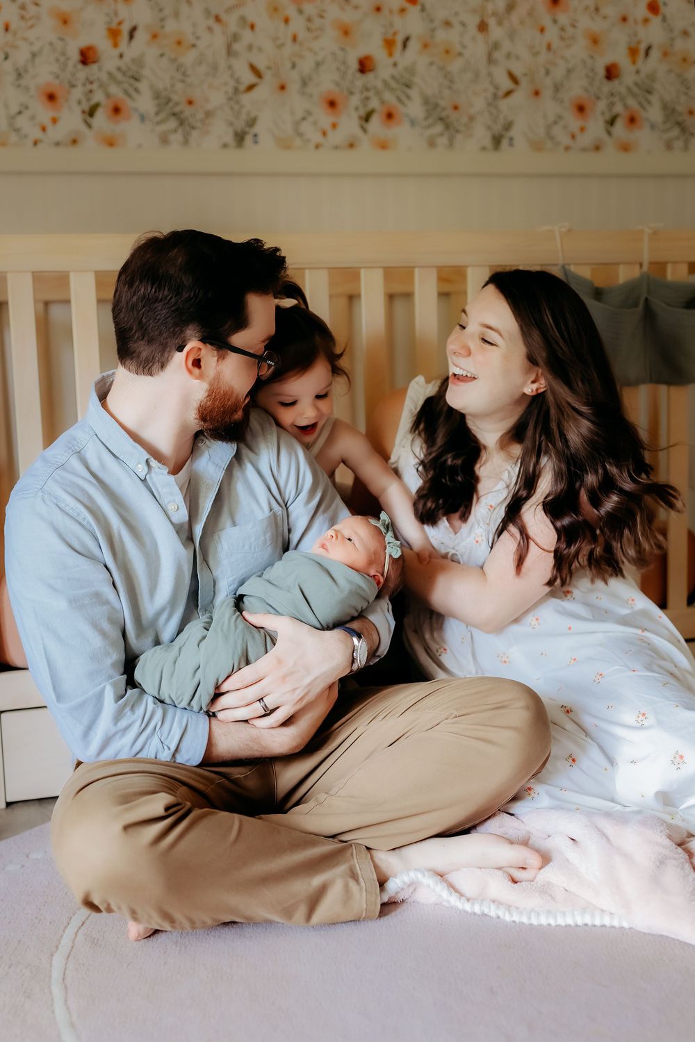 A tender family moment shared on a bed captures a series of loving interactions and embraces in matching light blue attire.
