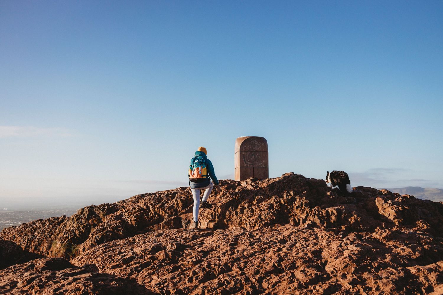 A series of panoramic coastal city views from mountain overlooks on a bright sunny day.