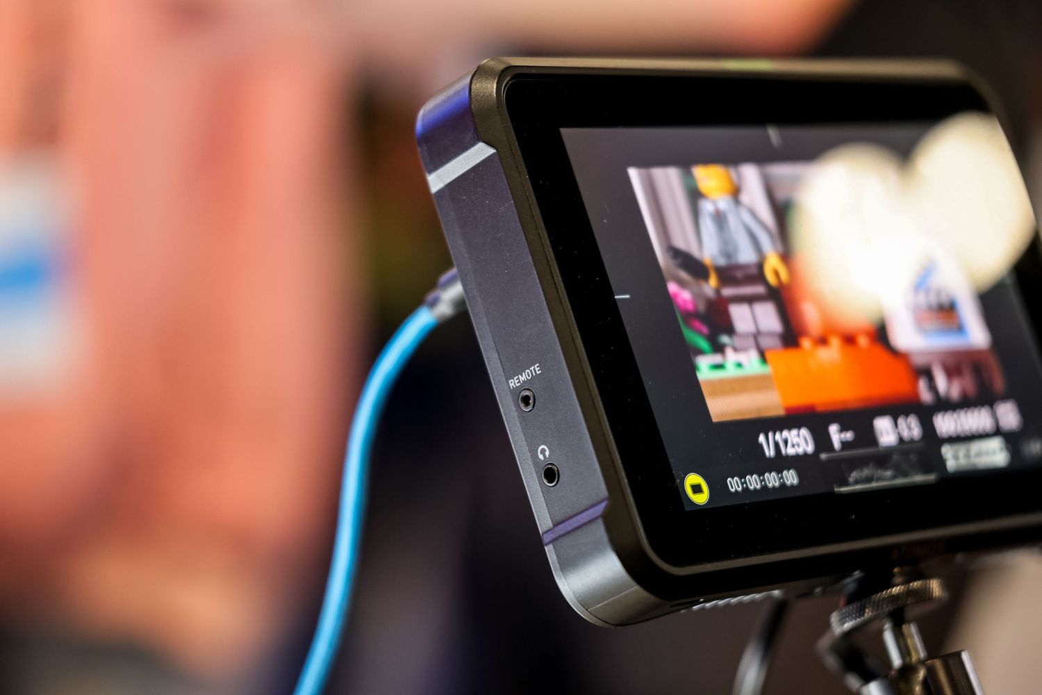 Close-up view of multiple video screens displaying broadcast monitor footage in a production setup.