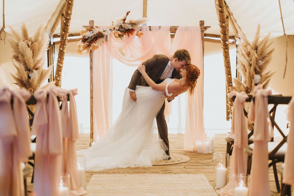 Romantic wedding couple posing together in a soft-lit elegant interior venue at Nuddock Wood Lake.