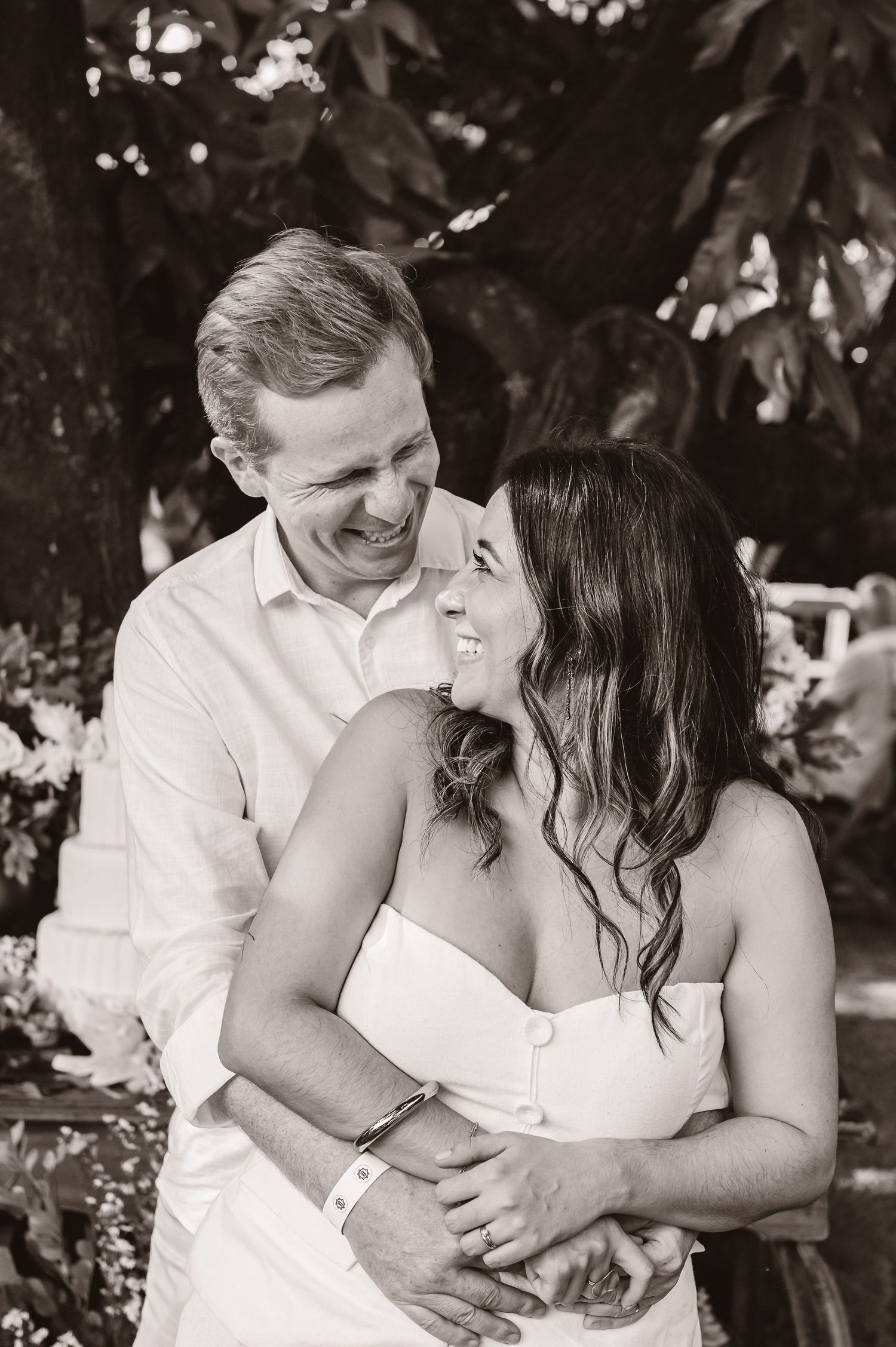 Black and white romantic portrait series of a couple embracing outdoors during an engagement photoshoot.