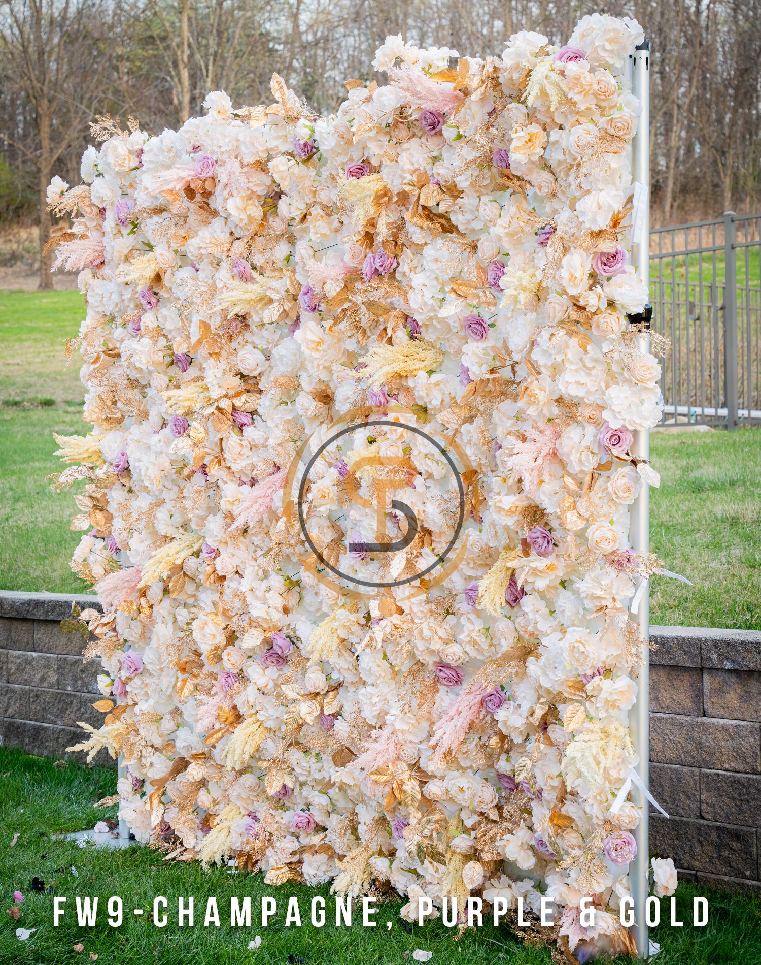 Champagne, purple, and gold floral wall backdrop with elegant circular logo design.