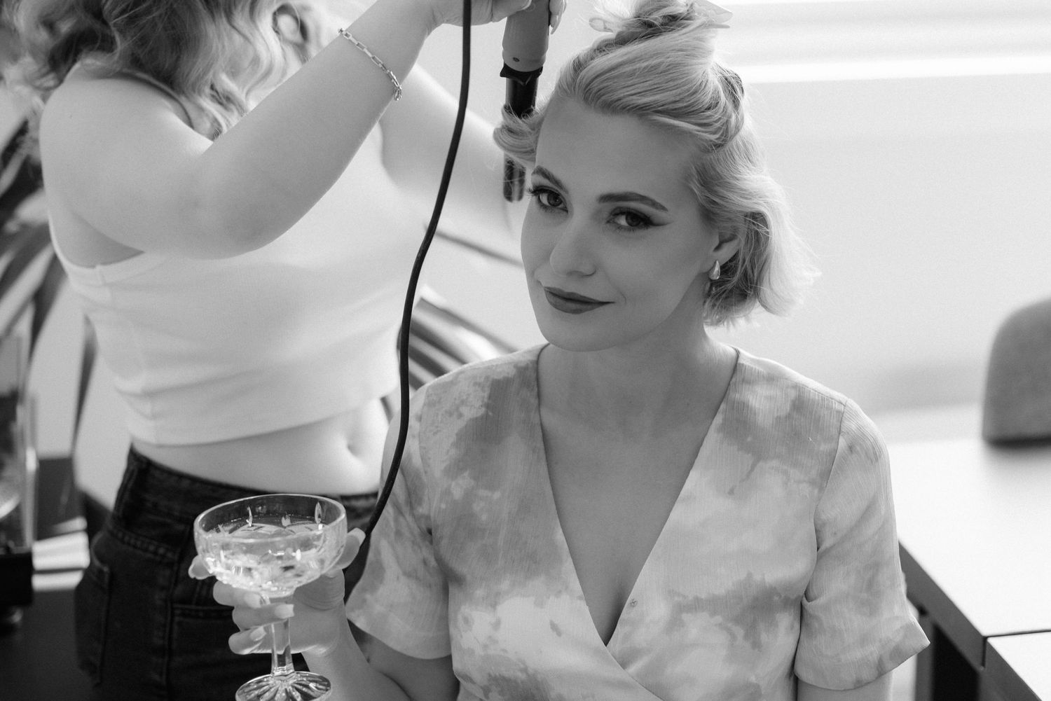Makeup artist applies eyeshadow to a model during a professional beauty session.